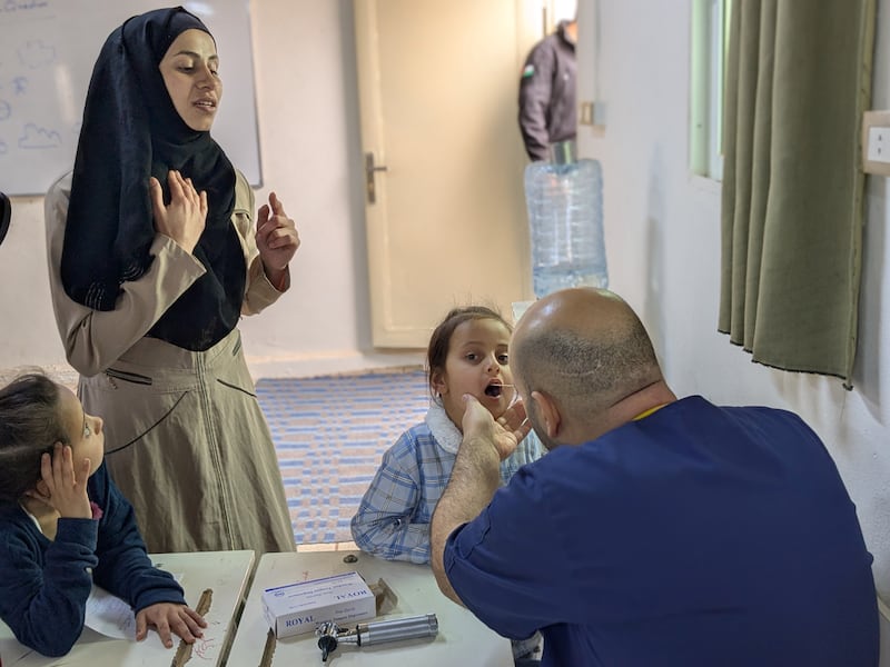 Refugee families gather for free medical treatment offered by Zarqa Baptist Church and The Church of Jesus Christ of Latter-day Saints near Zarqa, Jordan.