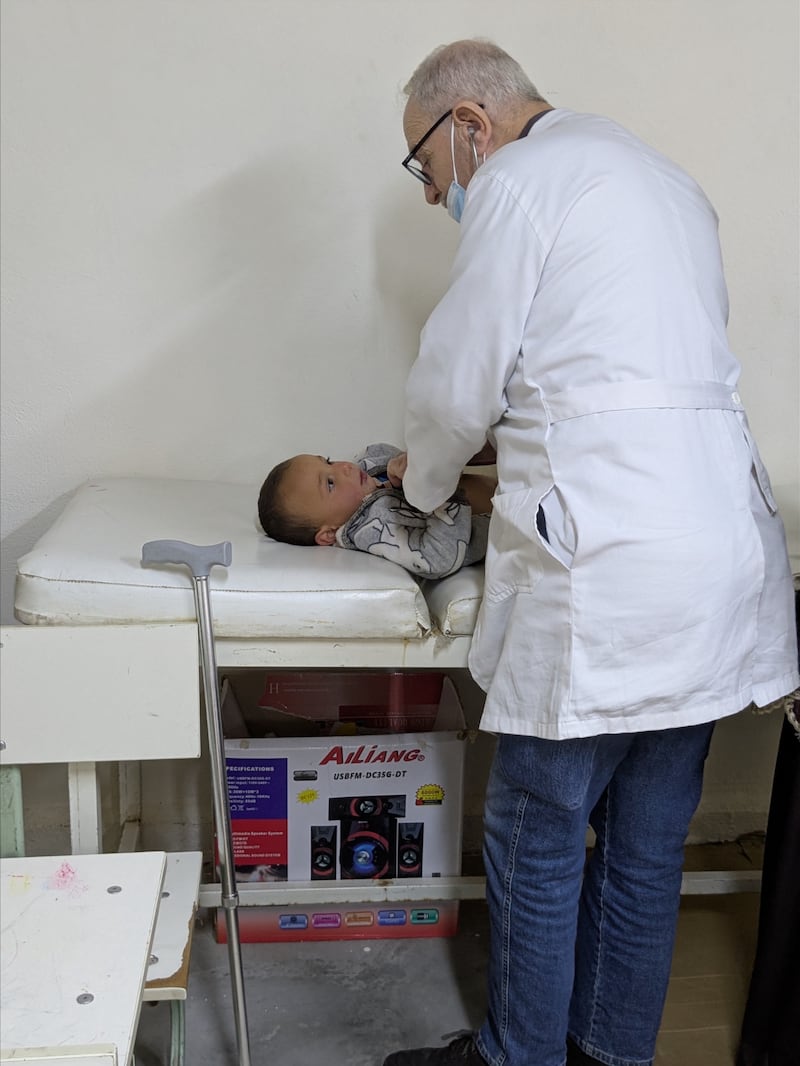 Refugee families receive care from the doctors at a monthly health clinic in the Mafraq settlement near Zarqa, Jordan, in 2025.