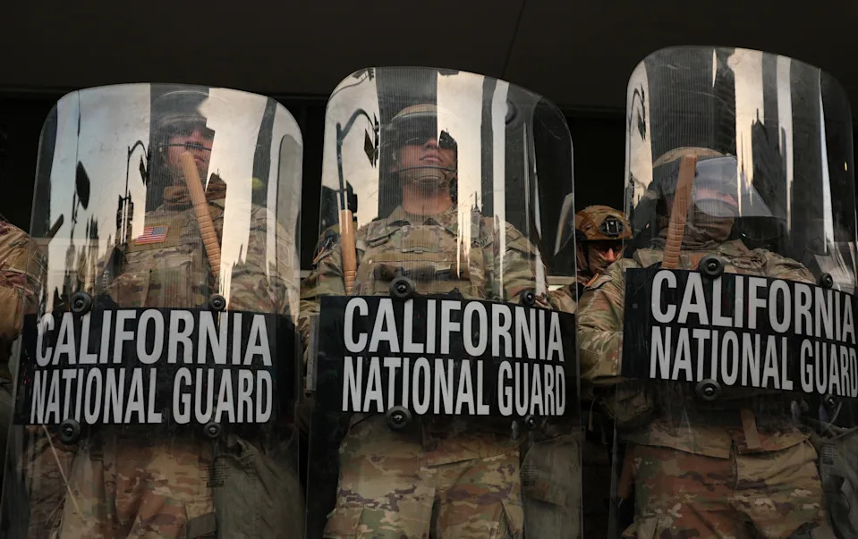 Patrick T. Fallon/AFP via Getty Images, FILE - PHOTO: California National Guard stand on the steps of the Federal Building after days of protests in response to federal immigration operations in Los Angeles, June 10, 2025.
