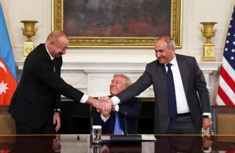 US President Donald Trump holds the hands of Azerbaijan's President Ilham Aliyev and Armenia's Prime Minister Nikol Pashinyan as they shake hands between each other during a trilateral signing event, at the White House, August 8, 2025. (credit: REUTERS/KEVIN LAMARQUE)