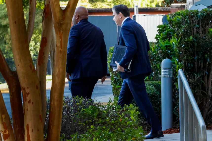 Deputy Attorney General Todd Blanche, right, leaves his hotel for the federal courthouse on Friday, July 25, in Tallahassee, Florida, to meet with Ghislaine Maxwell.