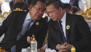 Cambodian Senate President Hun Sen, left, talks with his son, Prime Minister Hun Manet, during the 74th founding anniversary in Phnom Penh, Cambodia, on June 28. [AP/YONHAP]