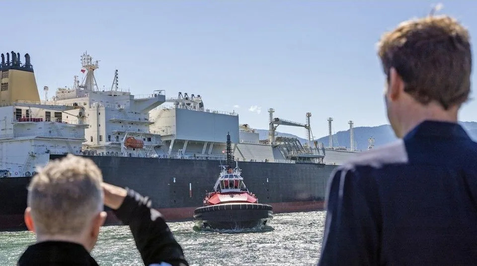  Premier David Eby (right) watches as a LNG carrier manoeuvres in Kitimat. LNG Canada, a consortium of five partners including Shell, Malaysian state-owned Petronas, PetroChina, Mitsubishi Corp. and KOGAS, is contemplating a $30-billion addition to its Kitimat plant that would nearly double its capacity to 26 million tonnes of LNG per year from 14 million tonnes per year now.
