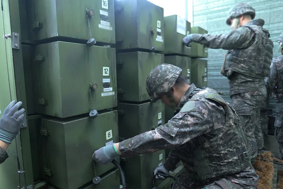 South Korean soldiers removing loudspeakers that were set up for propaganda broadcasts near the Demilitarized Zone separating the two Koreas in an undisclosed location in South Korea (South Korean Defence Ministry/AF)