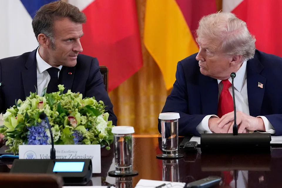 French President Emmanuel Macron and President Trump talk during a meeting with Ukrainian President Volodymyr Zelensky and European leaders in the East Room of the White House.