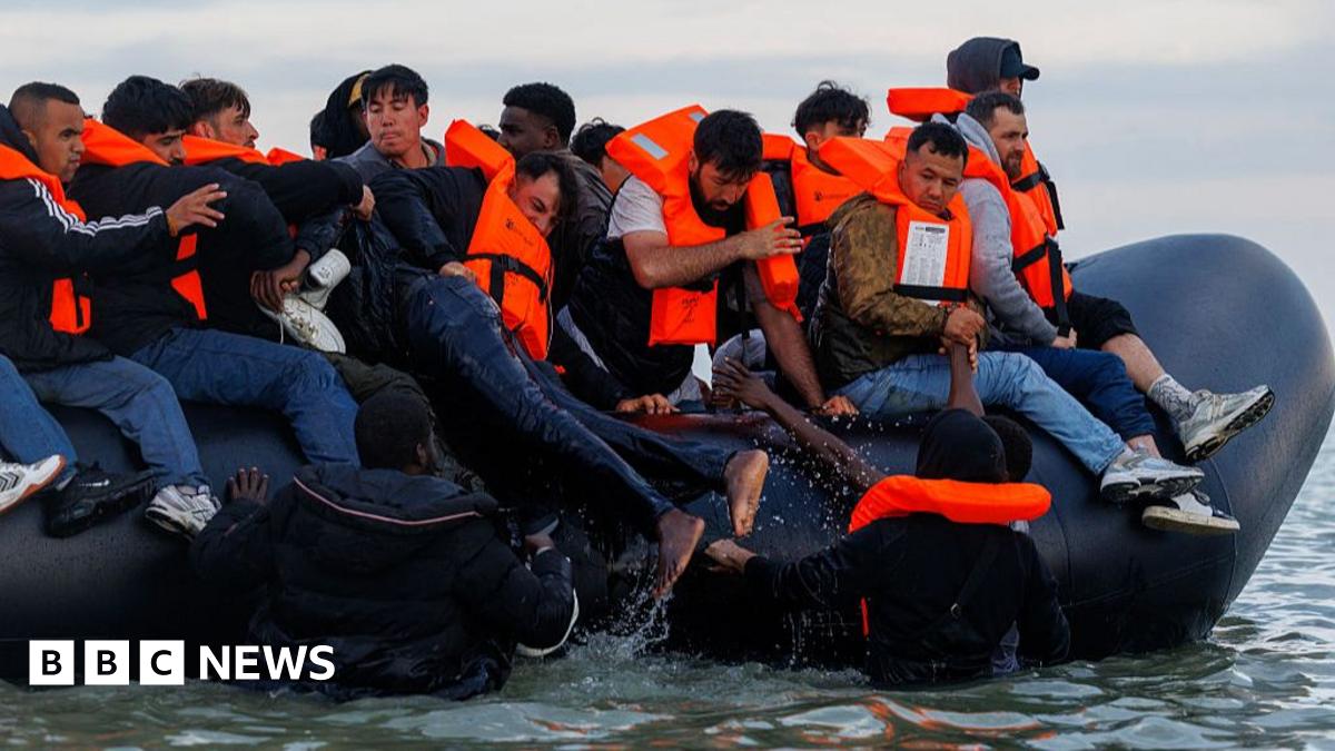 People clambering onto a small boat in the Channel near France