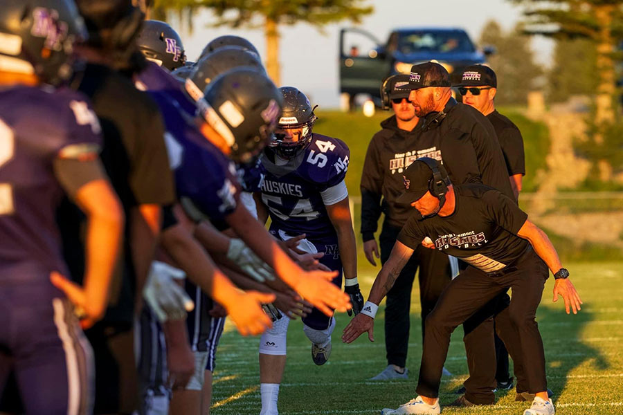 Keith Director, right, on the field with the North Fremont Huskies. During his first year as coach, he led the team to the quarterfinals.