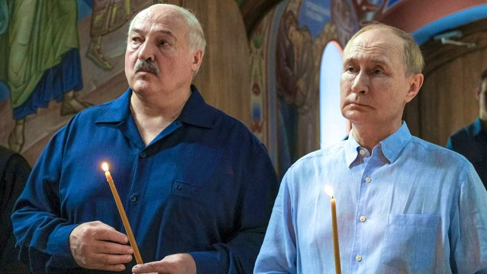 No choirboys: Alexander Lukashenko (left) and Vladimir Putin visit a place of worship in Valaam, Russia, on August 1.