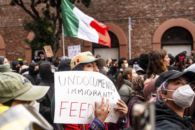 A protester holds a sign reading 