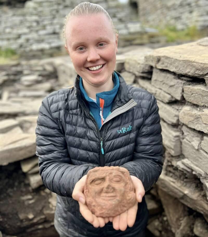 An archeology student digging on Scotland's Orkney Islands has uncovered a carved stone head that's estimated to be over 900 years old.