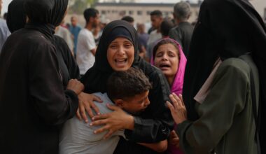 A woman whose son was killed while trying to reach aid trucks is comforted by relatives outside Shifa Hospital before her son's funeral in Gaza City, Thursday, Aug. 21, 2025. (AP Photo/Jehad Alshrafi)