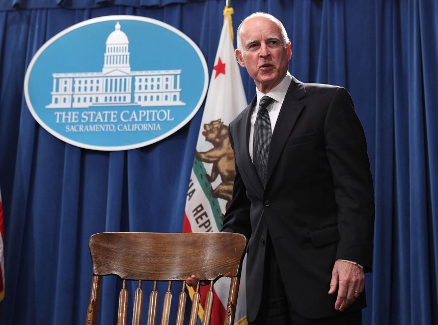 Former California Gov. Jerry Brown prepares to sign bills on March 24, 2011, in Sacramento, California.