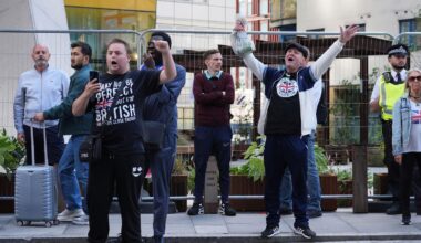 Police officer punched in face as masked protesters with children march through Canary Wharf shopping centre