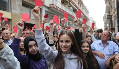 Turks from Western Thrace hold red cards and banners in Xanthi, Greece on September 25, 2023. (AA Photo)