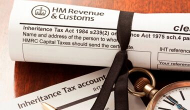 A rolled HM Revenue & Customs inheritance tax clearance certificate form tied with a black ribbon, an Inheritance Tax Account form, and a pocket watch