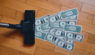 a vacuum sucking up dollar bills