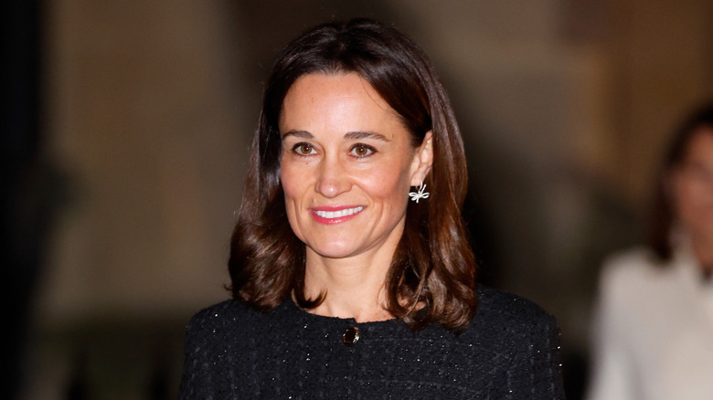 Pippa Middleton in a black dress with shoulder length hair