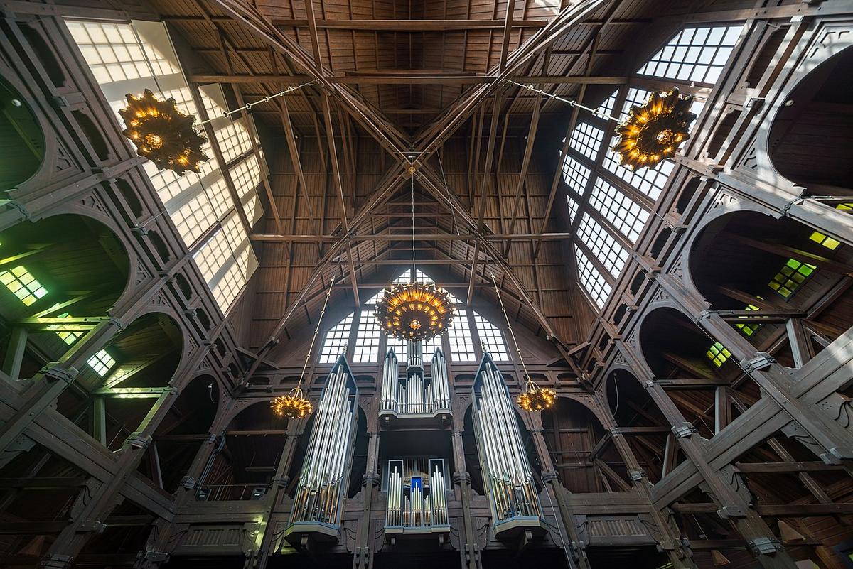 Interior of Kiruna Church, showing the pipe organ, windows, and ceiling.