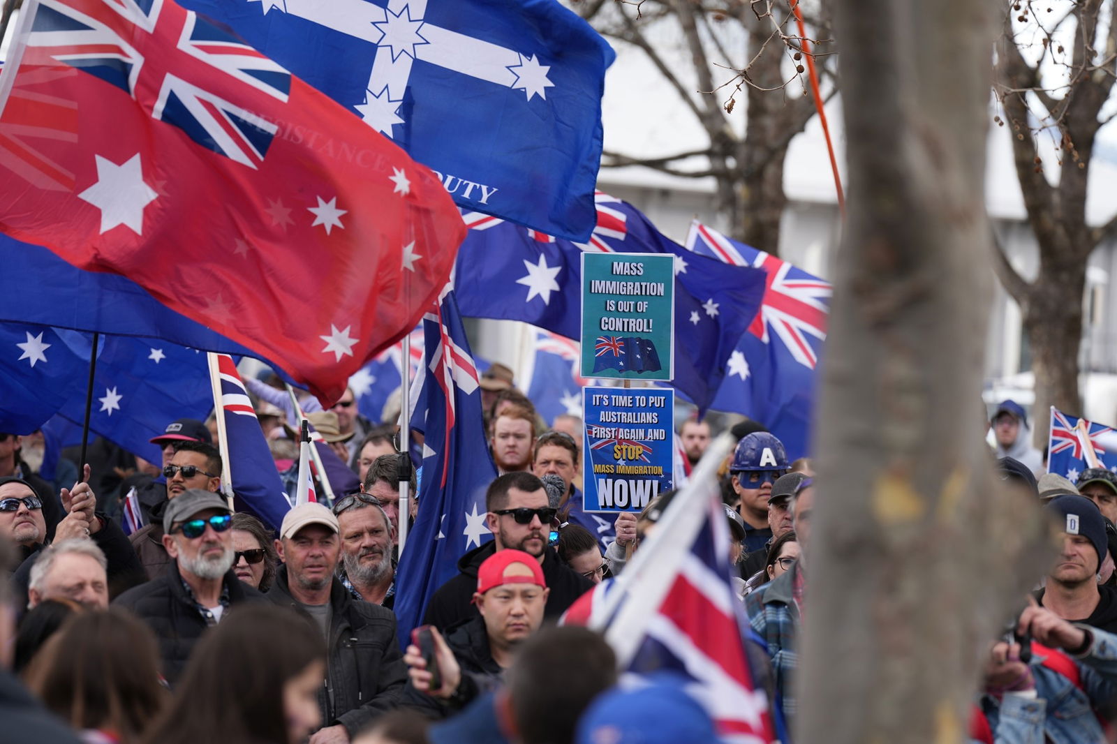 Signs and australian flags being held by crowds