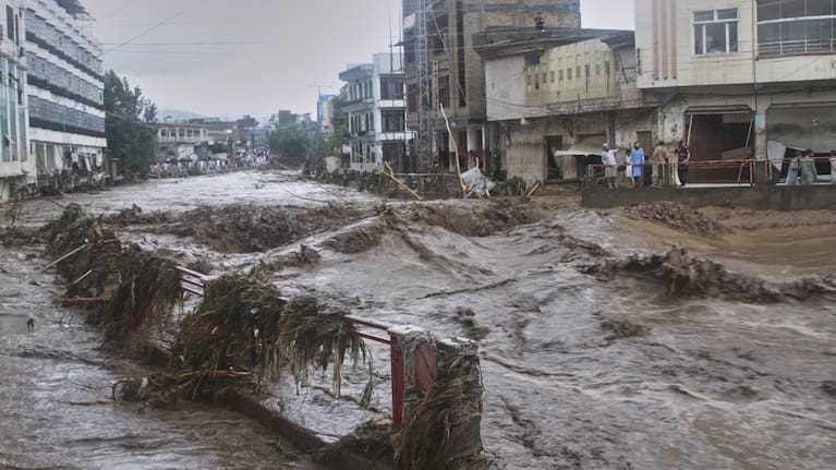 Local residents look at flash flooding due to heavy rains in a neighborhood of Mingora, the main town of Swat Valley, northwestern Pakistan, August 15, 2025.