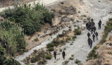 Members of Morocco's Auxiliary Forces sweep an area along the land border with Spain’s African enclave of Ceuta near Fnideq in northern Morocco on September 30, 2024.