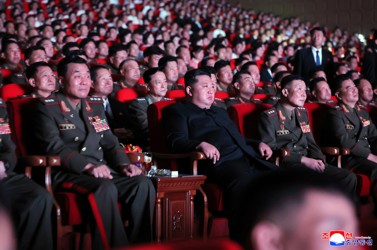 North Korean leader Kim Jong-un (C, front) watches a performance staged for commanders and combatants deployed to Russia's war with Ukraine after attending a ceremony to award state commendations to them and comfort the bereaved families of fallen soldiers, in this undated photo released by the North's official Korean Central News Agency on Friday. (Yonhap)