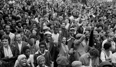 Anti-racists gather to block the route of a National Front demonstration, New Cross Road, August (1977)