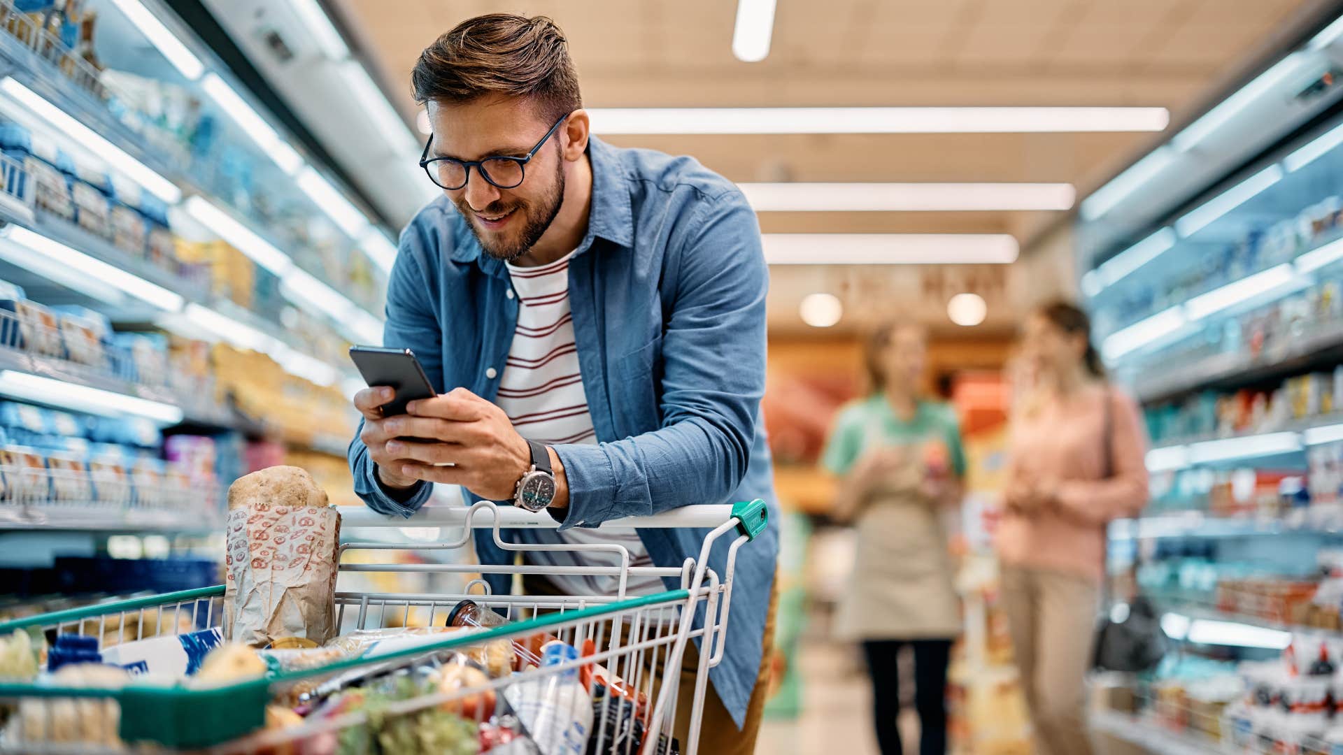 man buying items on sale at the grocery store