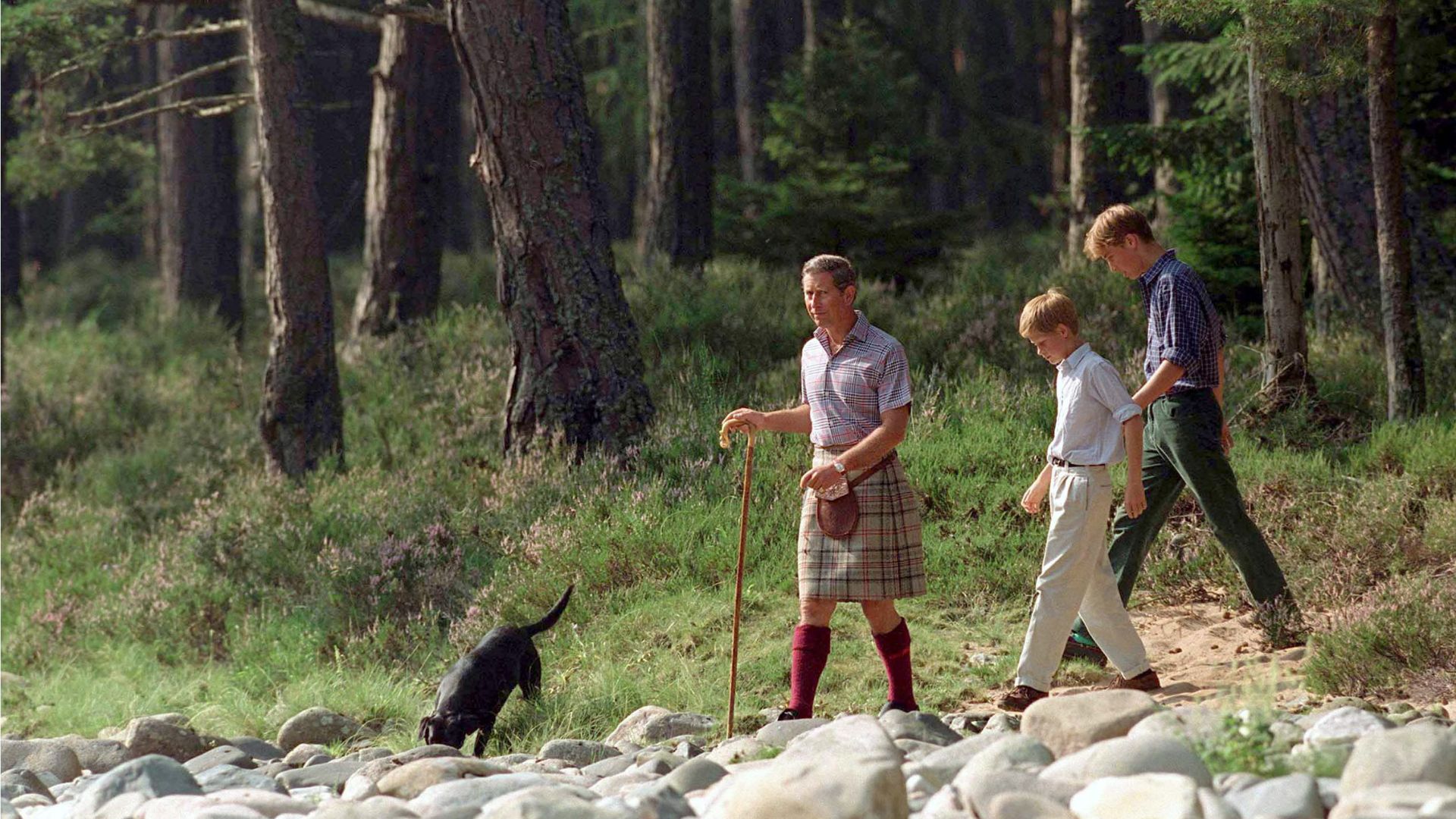 King Charles, Prince William and Prince Harry walking around Balmoral with a dog in 1997