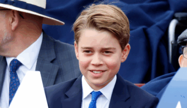 Prince George smiling in a blue suit and tie