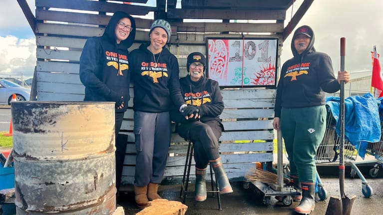 Te Owaina Gibson, Te Kotuku Irwin-Stainon, Ngati Oneone Chairwoman Charlotte Gibson and Tahea Gibson stand by the "Reclamation of whenua" fire, which has been burning for 101 days.