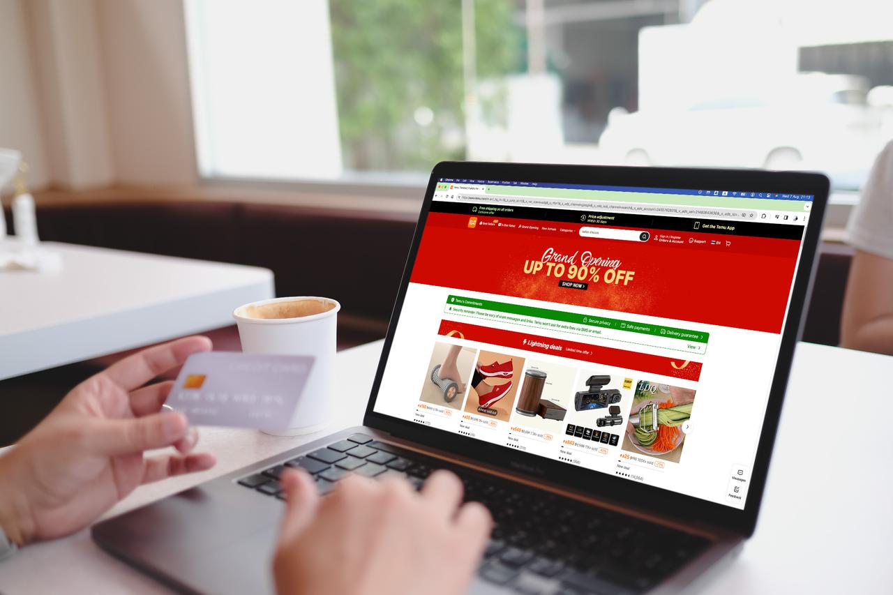 A person shops on Temu’s online marketplace using a laptop in Bangkok, Thailand, February 8, 2025. (Adobe Stock Photo)