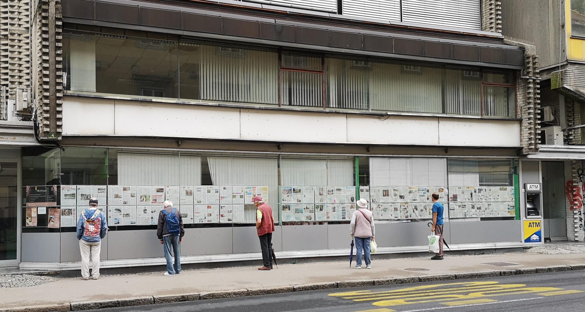 Older folks reading the newspaper in Ljublijana, Slovenia