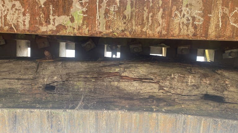 The cracking of the overhead impact beam needs to be replaced.