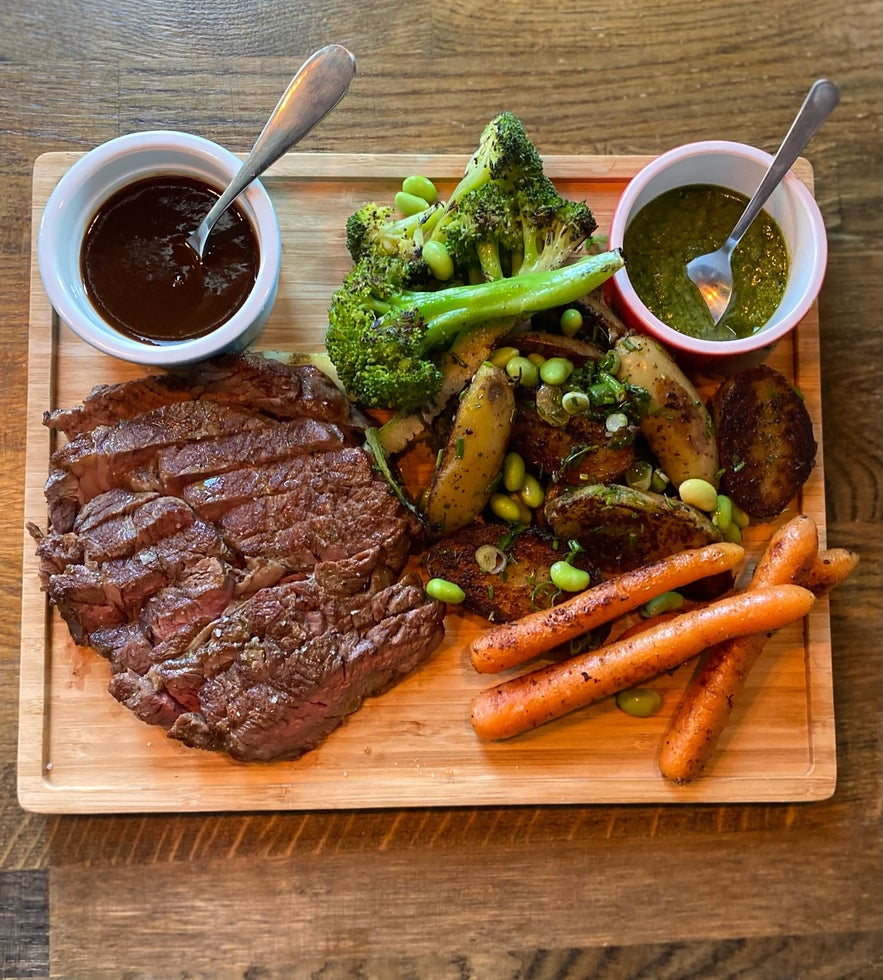 Sirloin steak with roasted sweet potatoes, broccoli, and two delicious sauces at Lilly & Julia’s – Viking BBQ.