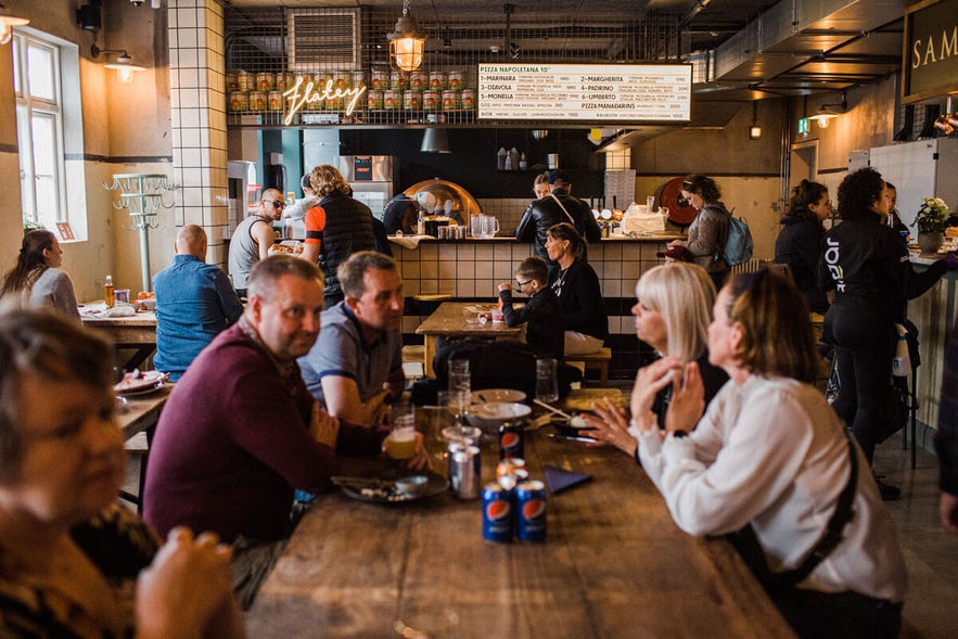 Bustling scene with customers dining at the Old Dairy Food Hall in Selfoss, Iceland.