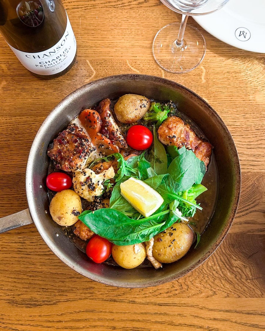 Delicious pan-fried chicken with potatoes, tomatoes, and fresh greens at Mar Seafood in Selfoss, Iceland.