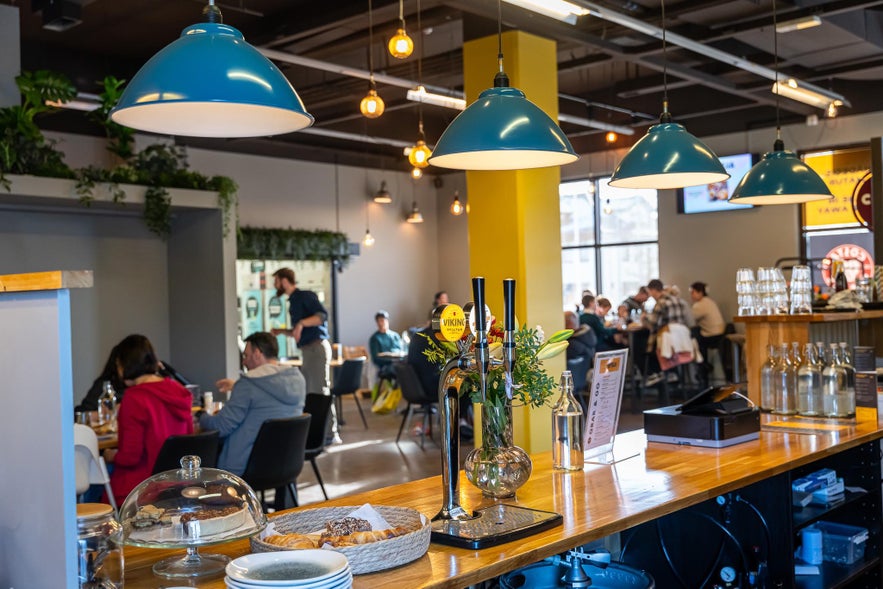 Cozy interior of Byrja restaurant in Selfoss, Iceland, featuring warm lighting and inviting seating.
