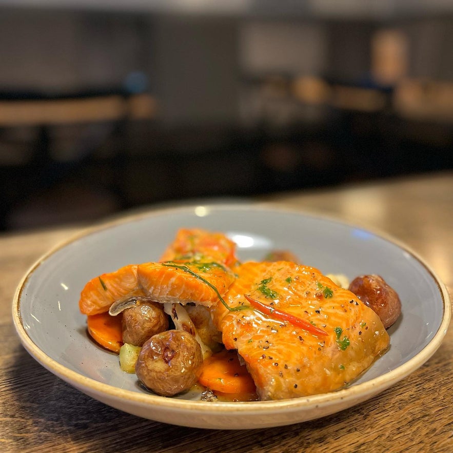 Perfectly cooked salmon with roasted potatoes and carrots at Kaffi Krus in Selfoss.