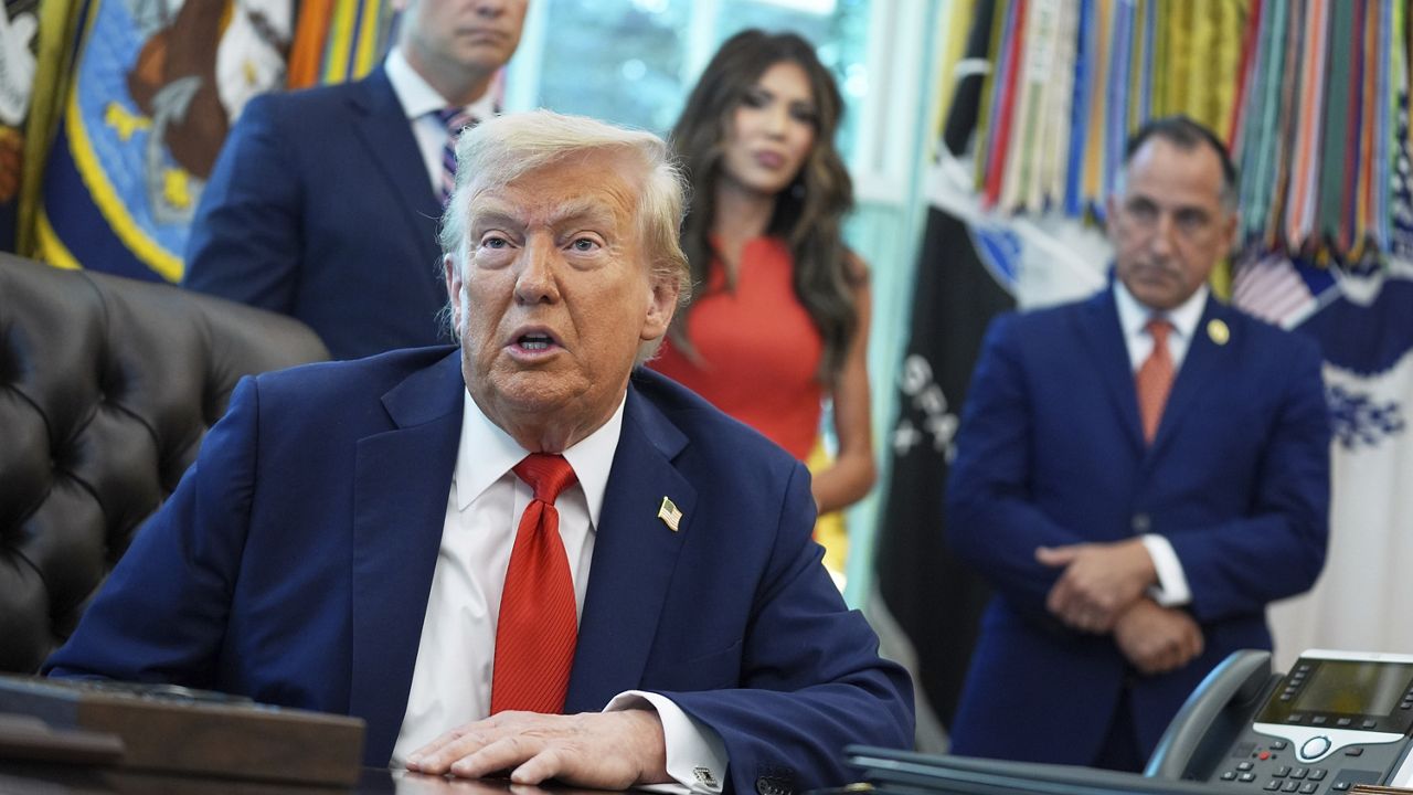 President Donald Trump speaks as he signs executive orders in the Oval Office of the White House, Monday, Aug. 25, 2025, in Washington. Standing with the President from left are, Secretary of Defense Pete Hegseth, Homeland Security Secretary Kristi Noem and Director of U.S. Federal Marshall Service Gadyaces Serralta. (AP Photo/Evan Vucci)
