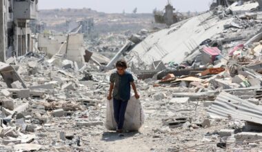 A Palestinian girl transports salvaged items next to destroyed buildings in the al-Tuffah neighbourhood of Gaza City on August 14, 2025. (AFP Photo9