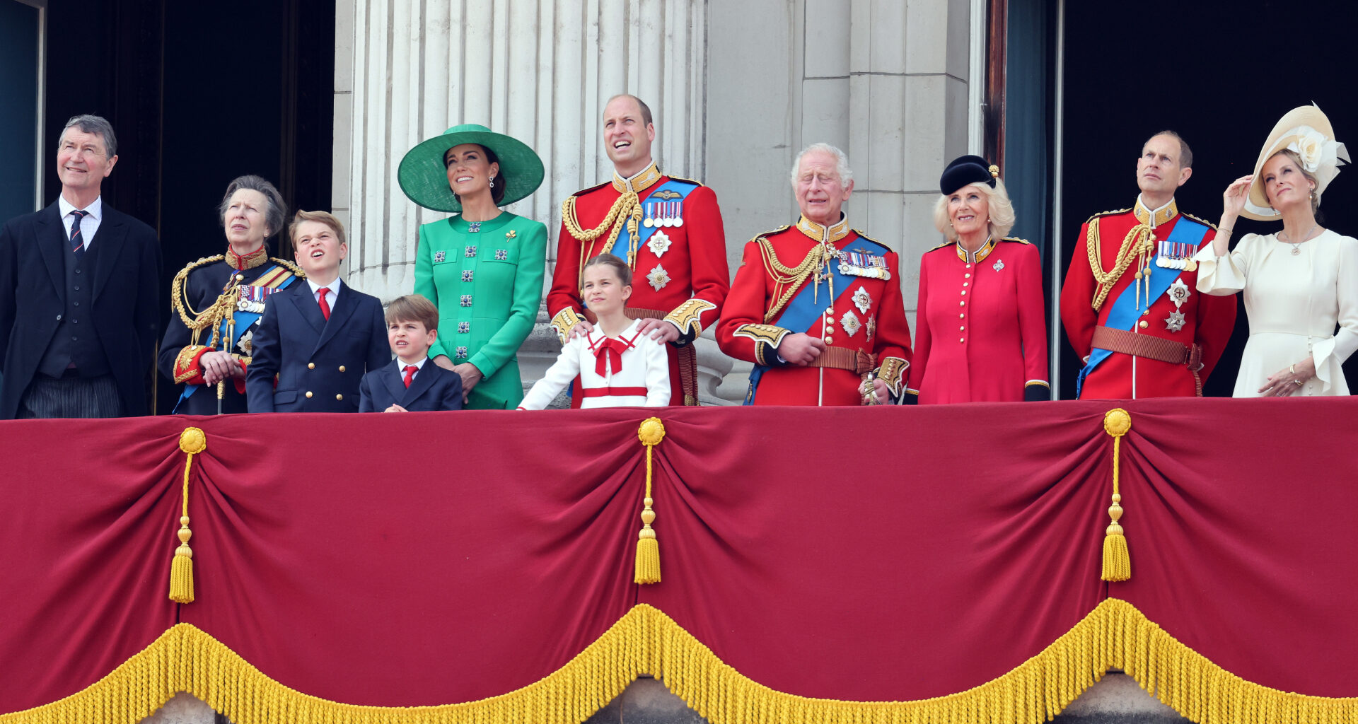 The King, Queen and other members of the royal family in dresses and military uniforms on the balcony at Buckingham Palace during Trooping the Colour 2023