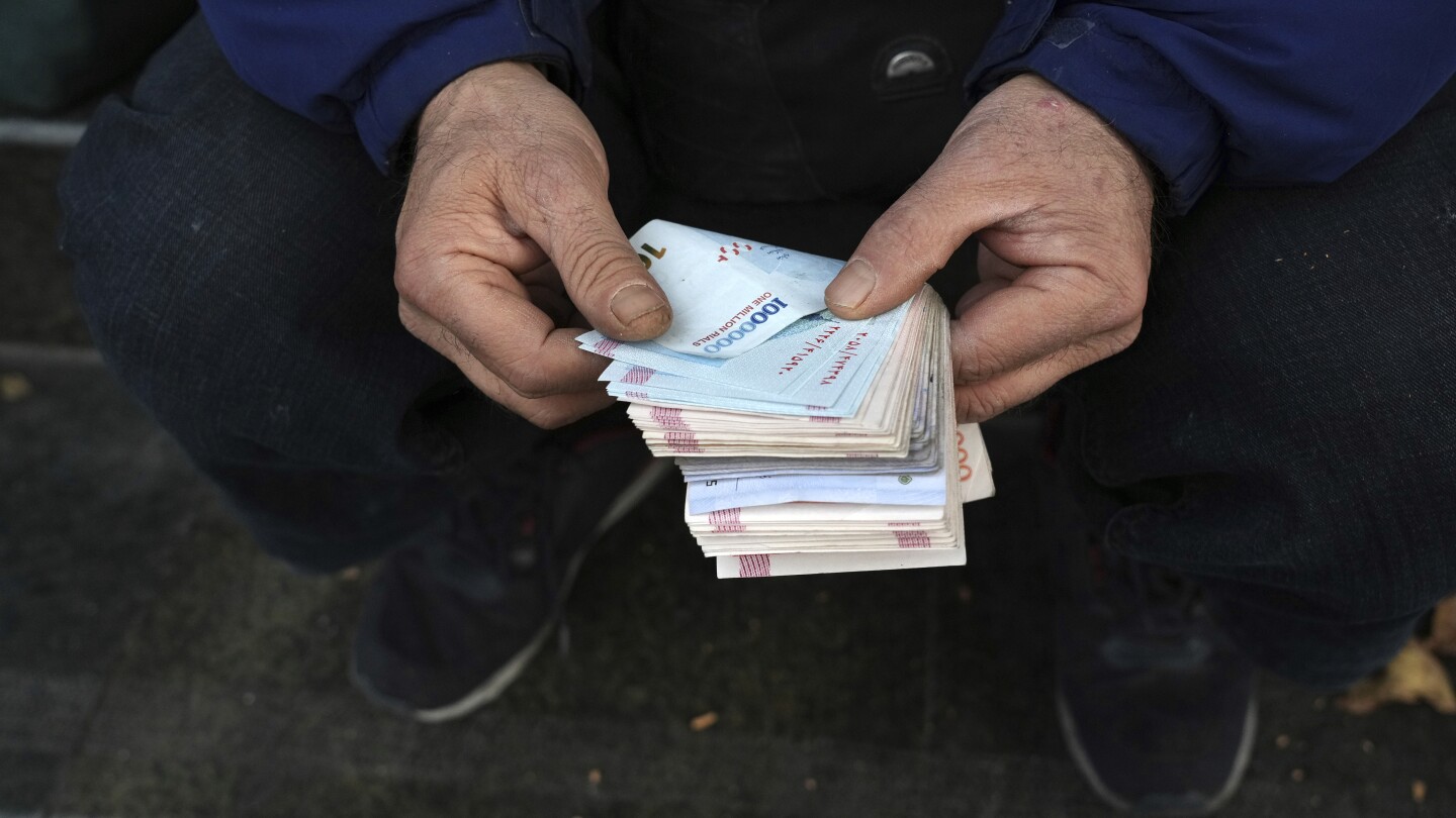 Iran's rial currency falls on 'snapback' sanctions threat