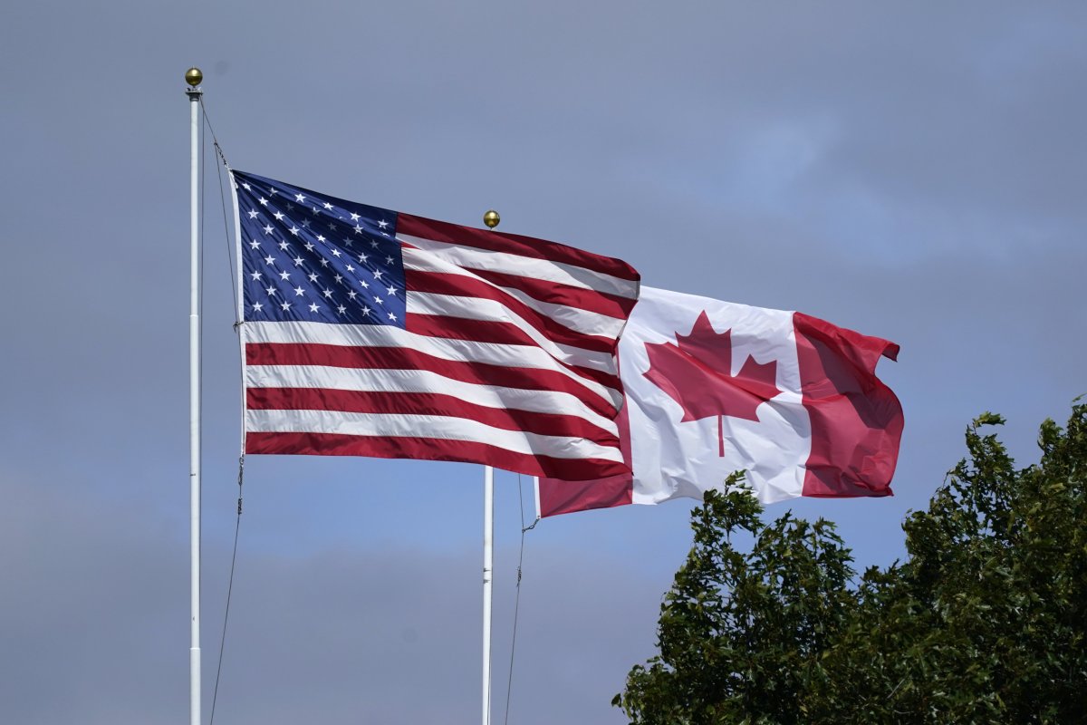 U.S. and Canadian flags fly together 