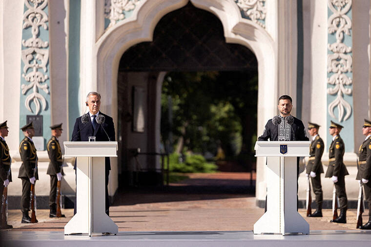 UKRAINES PRESIDENT VOLODYMYR ZELENSKIY VIA TELEGRAM/HANDOUT VIA REUTERS
Ukraines President Volodymyr Zelenskyy and Canadas Prime Minister Mark Carney attend a joint press conference, amid Russias attack on Ukraine, on Ukraines Independence Day, in front of St. Sophias Cathedral in Kyiv, Ukraine.