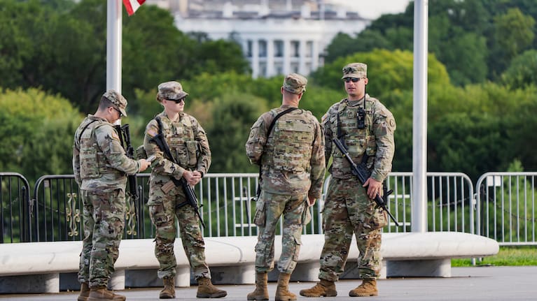With the White House in the distance, National Guard troops patrol the Mall as part of President Donald Trump's order to impose federal law enforcement in the nation's capital, in Washington, Thursday, Aug. 28, 2025. 