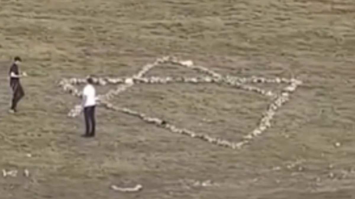 Group of Jewish tourists are filmed dismantling landmark cross on Welsh hillside and using the stones to create a giant Star of David in its place