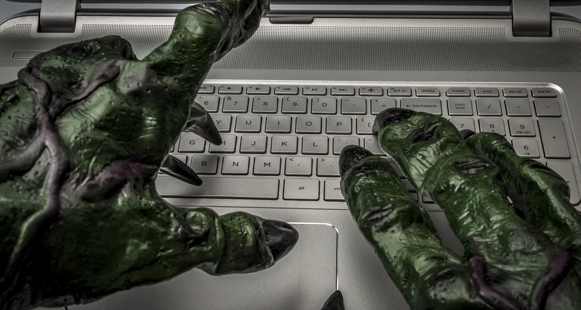 Monster hands typing on keyboard