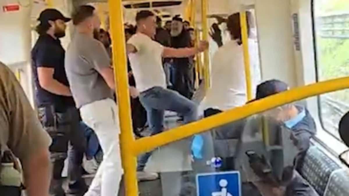 Vigilante commuter who stepped in when passenger dropped his trousers in front of children on packed London Tube is now questioned by police