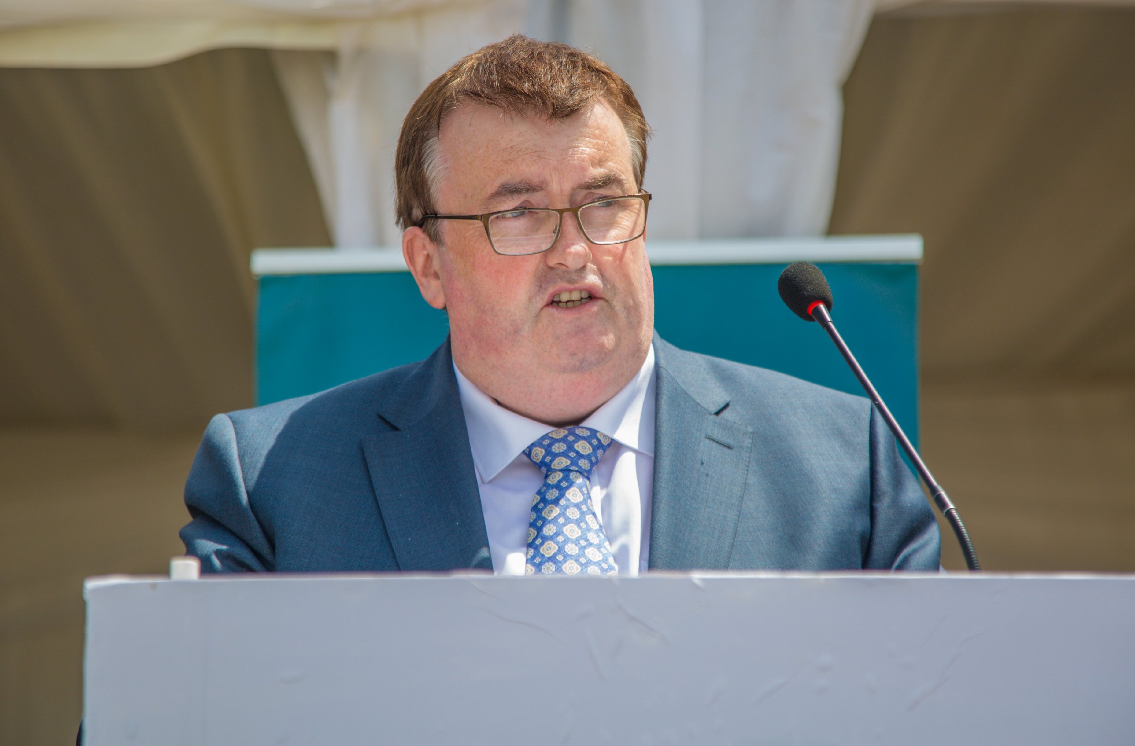 Minister Colm Brophy speaking at a COVID-19 vaccination site.